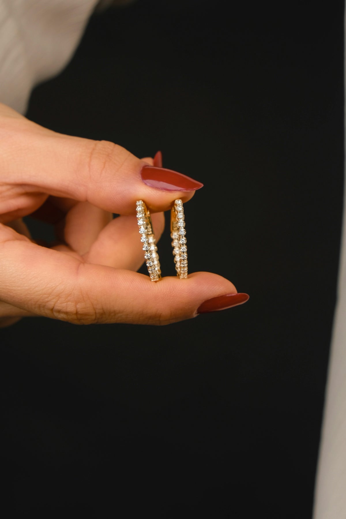 A woman holding two rings in her hand