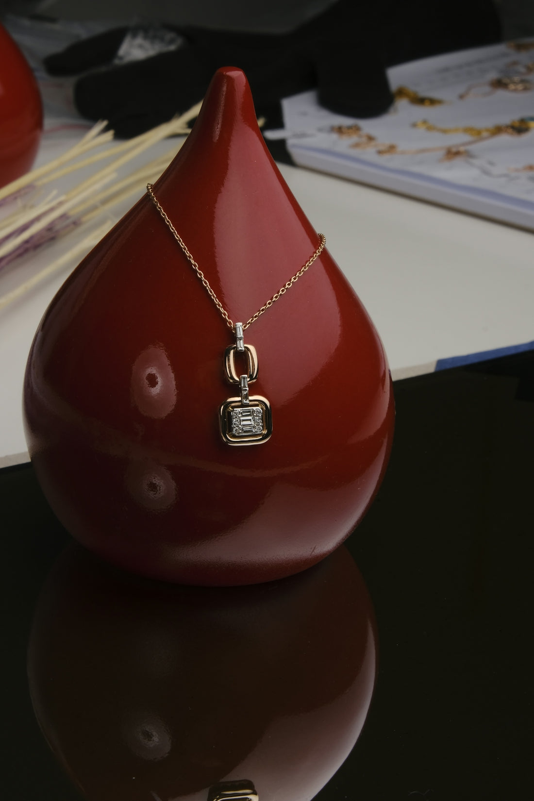 A red vase sitting on top of a table
