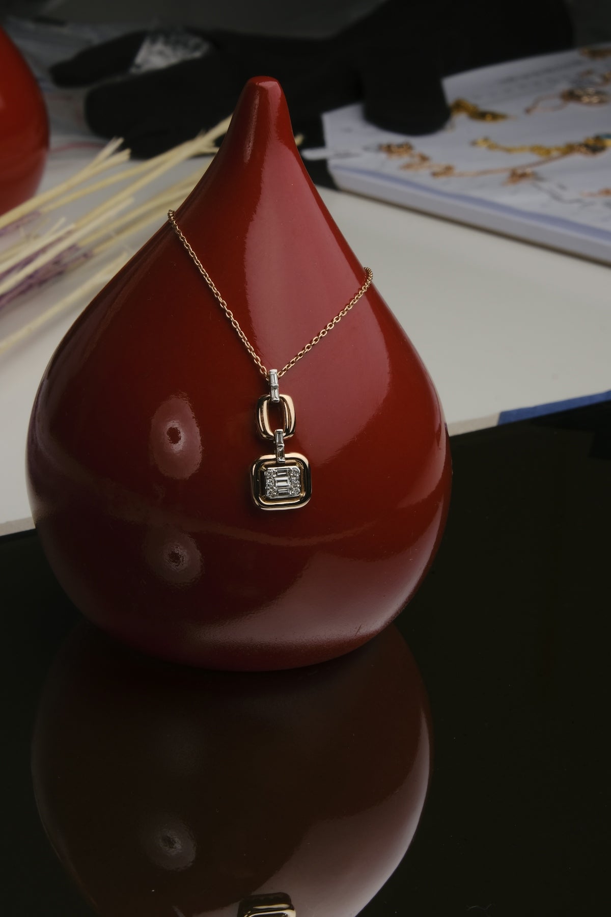 A red vase sitting on top of a table