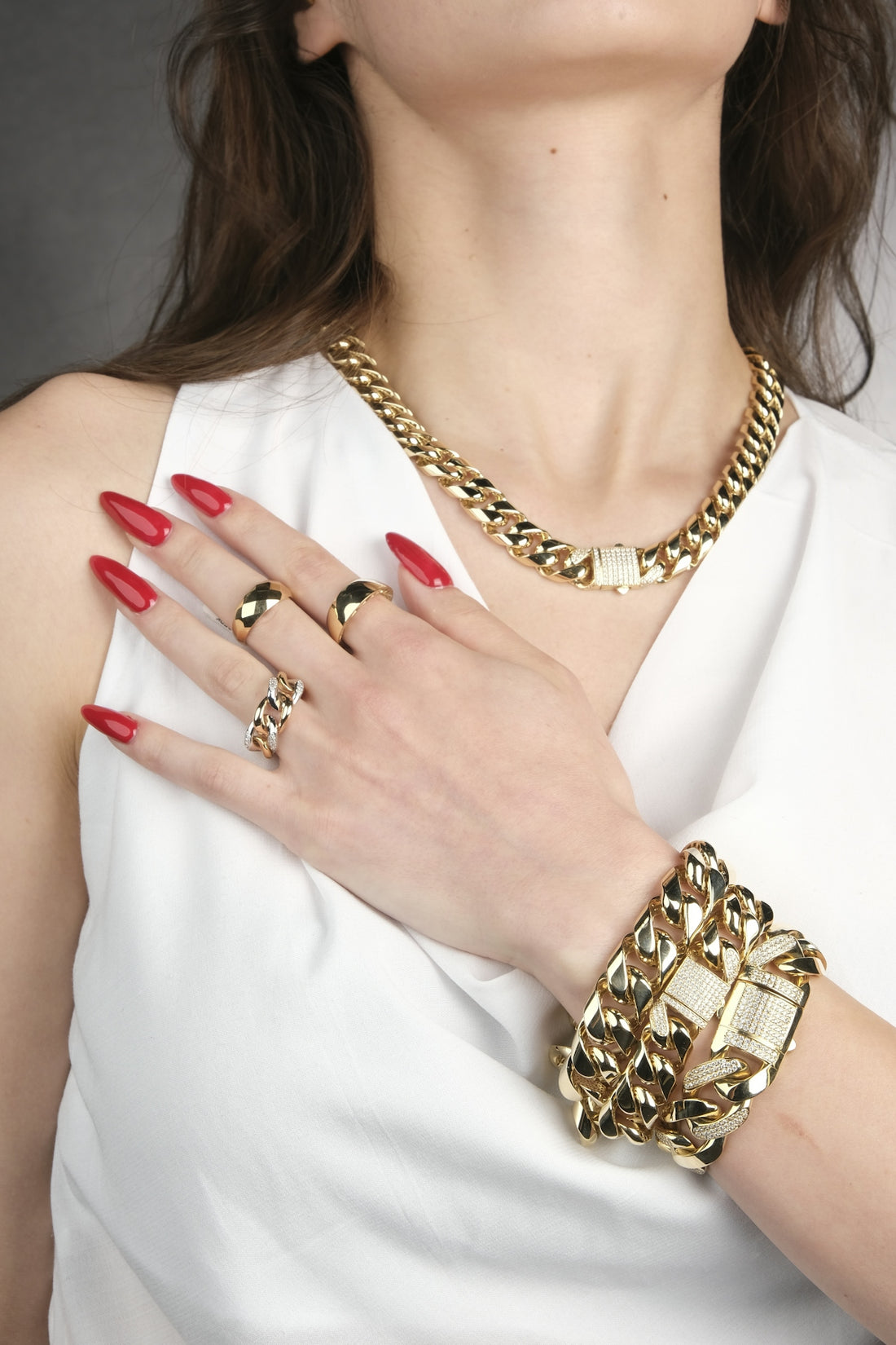 A woman in a white dress with red nails
