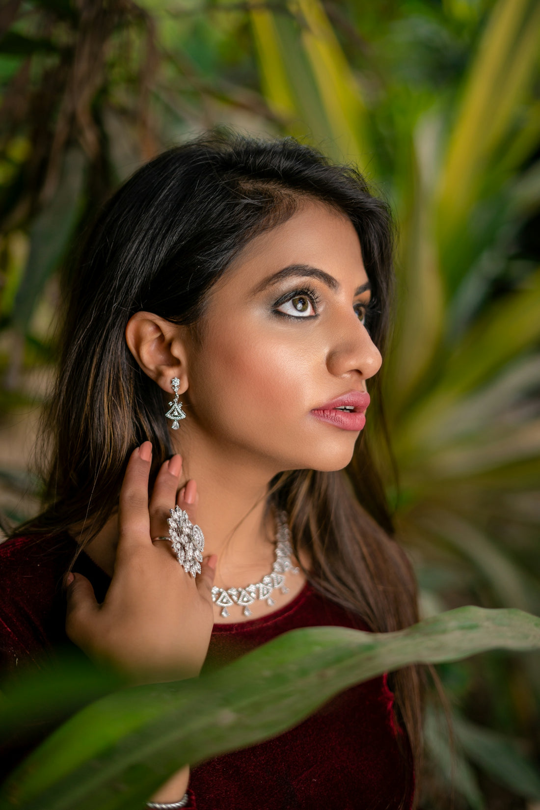 A woman in a red dress is posing for a picture