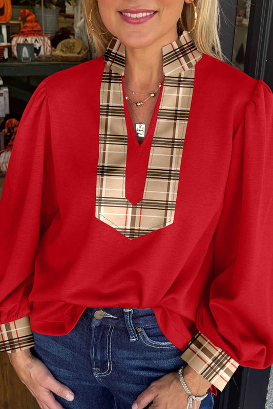 Red Tartan Fusion V‑Neck Blouse with plaid trim on neckline and cuffs, styled with jeans for a casual feminine look.