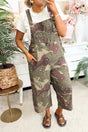 Woman wearing green camouflage and leopard print denim overall cropped jumpsuit with adjustable straps, front view, Fashionfitz UK