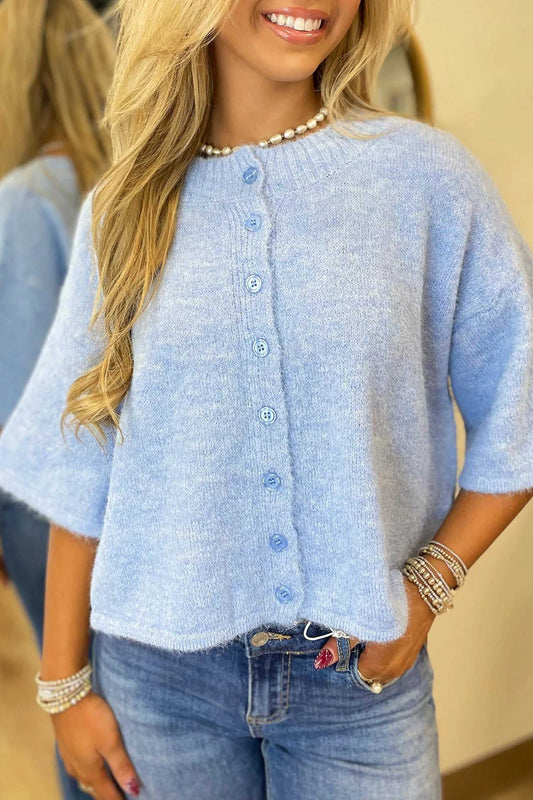 Fuzzy knit cardigan women in pastel blue with boxy fit and 3/4 sleeves, styled with denim jeans for a casual look.