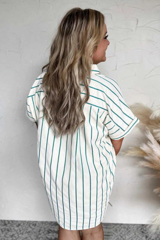 Woman wearing a green and white striped shirt against a textured white wall.