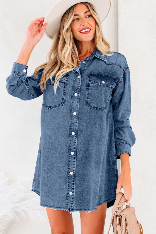 Oversized denim dress women with raw hem, long sleeves, and button front in medium blue. Features chest pockets and relaxed fit for casual wear.