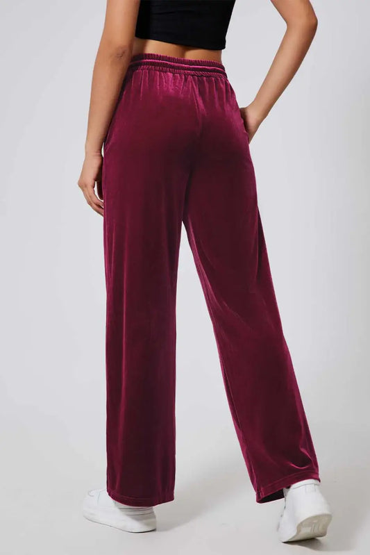 Back view of soft burgundy velvet yoga pants featuring relaxed wide-leg fit and elastic waistband, ideal for lounging or daily wear.