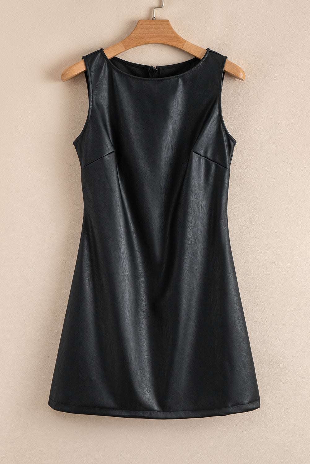 Black Vegan Leather Sleeveless Mini Dress on hanger, highlighting its minimalist design and cruelty-free PU leather material from FashionFitz.