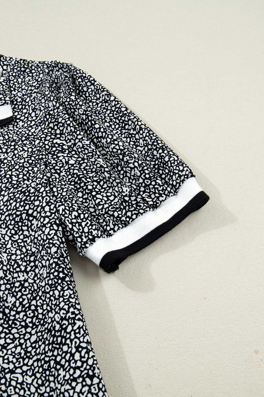 Detail of puff sleeve on Black Leopard Polo Mini Dress with black and white cuff. Lightweight fabric and leopard print create a stylish summer look.