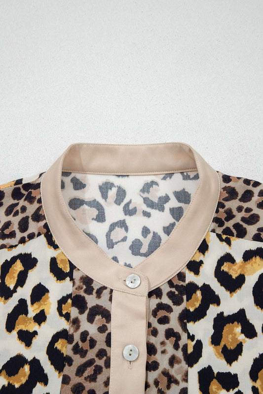 Close-up of collar and button placket on khaki leopard panelled shirt showing mixed animal print and lightweight fabric.