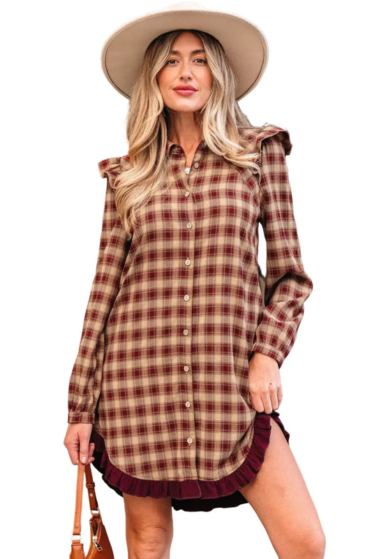 Woman wearing a plaid dress with a hat in an outdoor setting