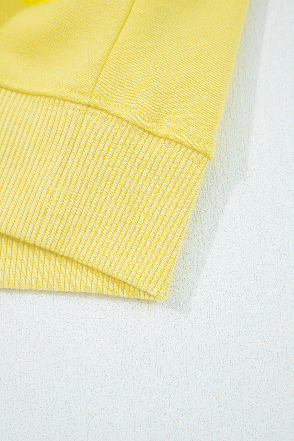 Hem detail of yellow Drop Crop Wide-Leg Pants Set top, showing ribbed edge for a polished loungewear look.