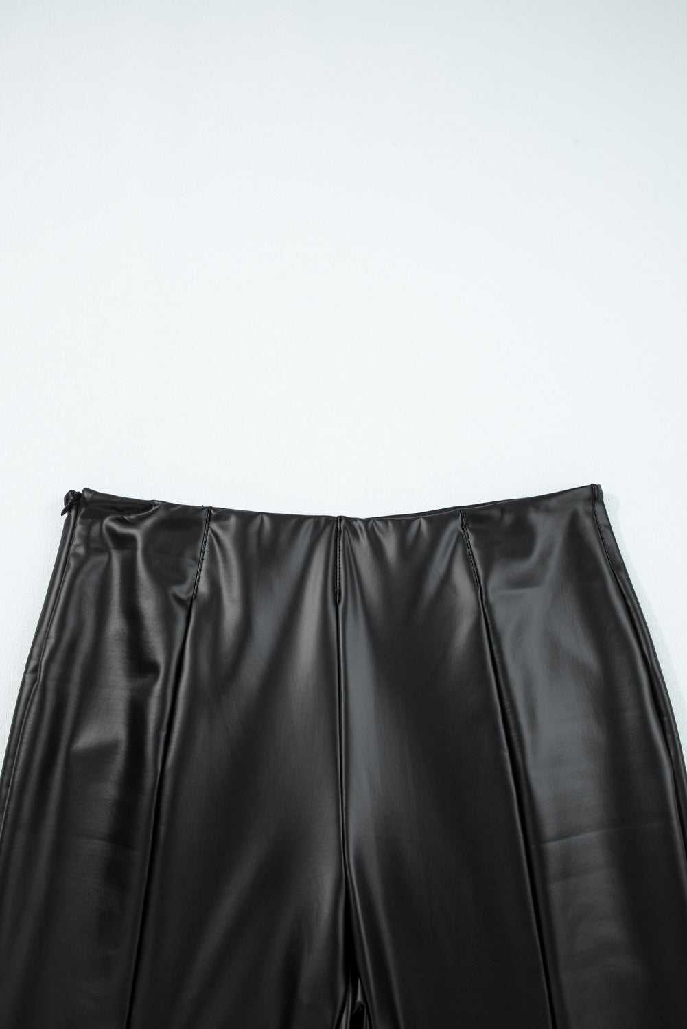 Top waistband detail of Black Vegan Leather Leggings – High‑Rise Skinny Fit showing clean lines and structured high-rise fit.