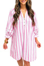 Woman wearing a pink and white striped dress against a plain background