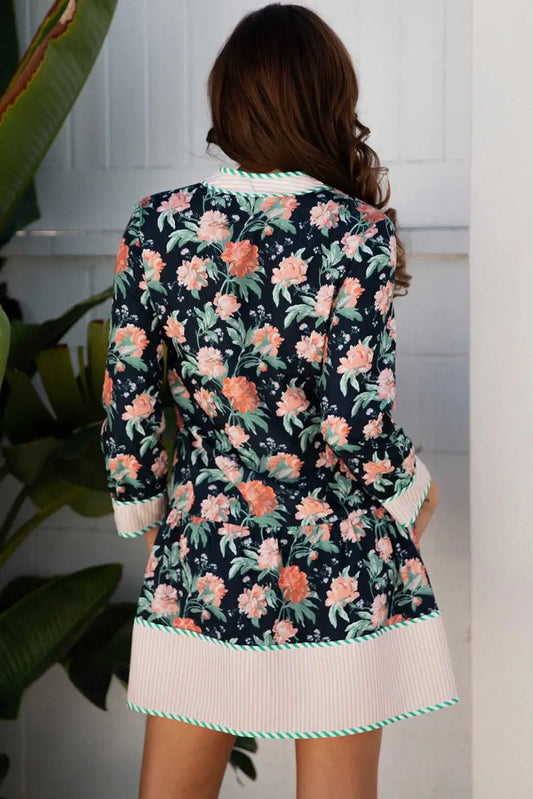 Back view of the Ladies Blue Floral Shift Mini Dress with striped hem and cuffs, showcasing all-over floral print and feminine Southern Belle style.