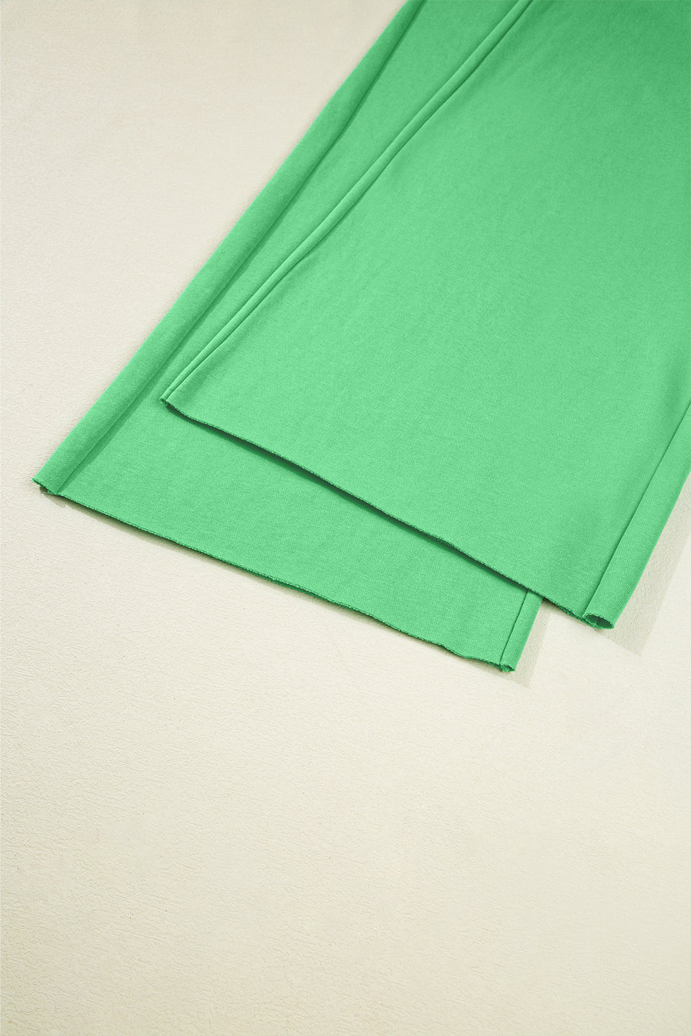 Wide-leg hem detail of green Drop Crop Pants, showcasing flowy silhouette and soft fabric for relaxed fashion.