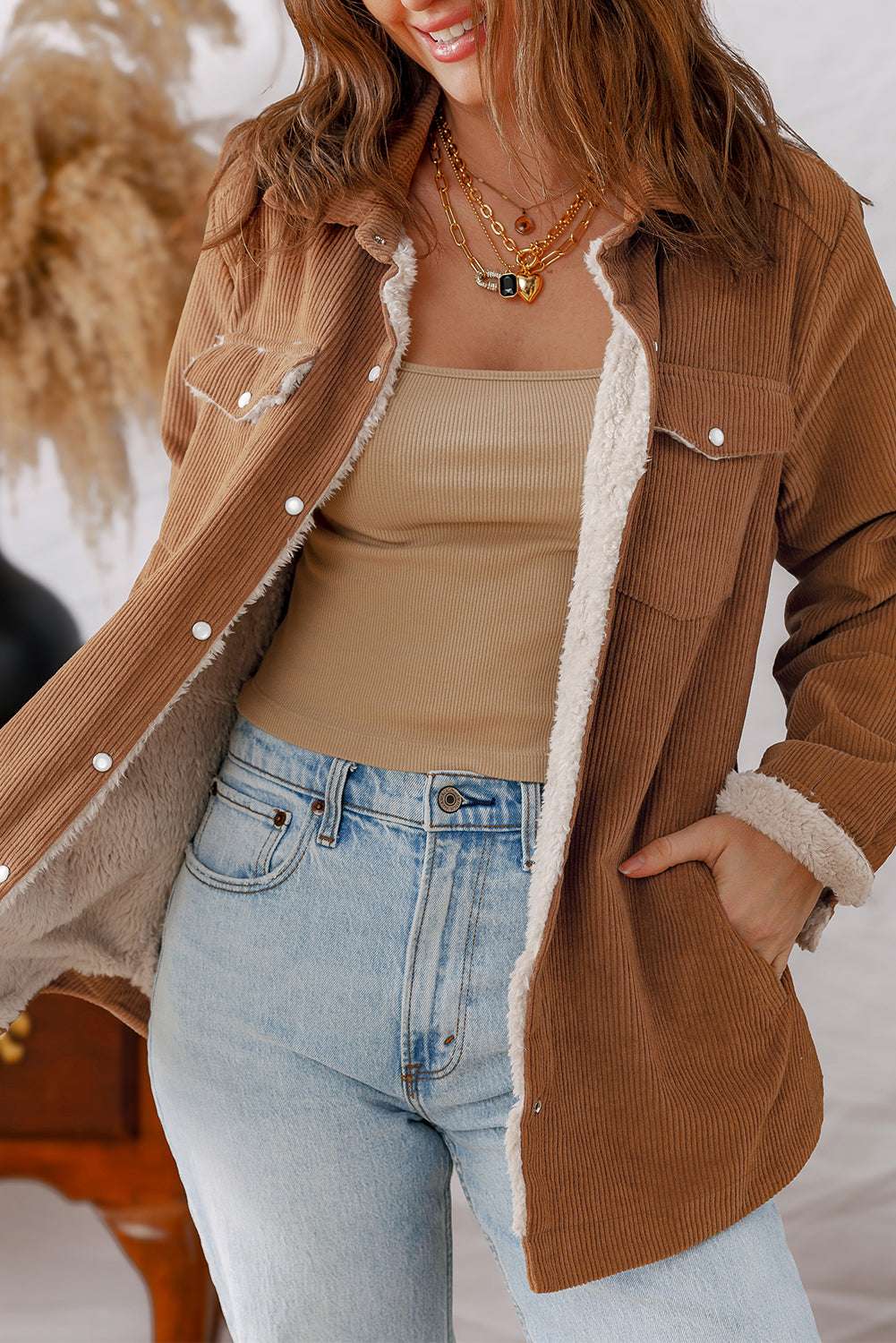 Close-up of warm Corduroy Jacket with fleece lining and side pocket, styled with denim for a casual winter look.