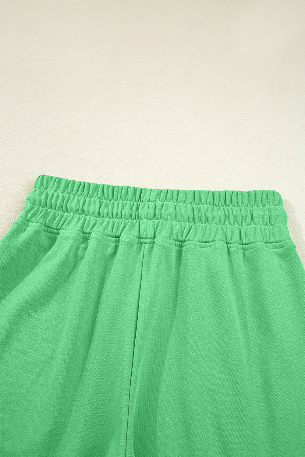 Back waistband detail of green Drop Crop Pants, featuring elastic fit for comfort and flexibility in daily wear.
