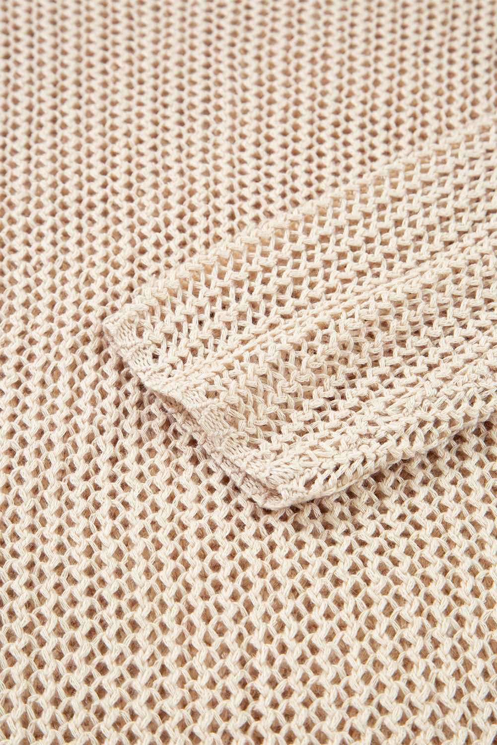 Close-up of beige textured fabric with a folded corner