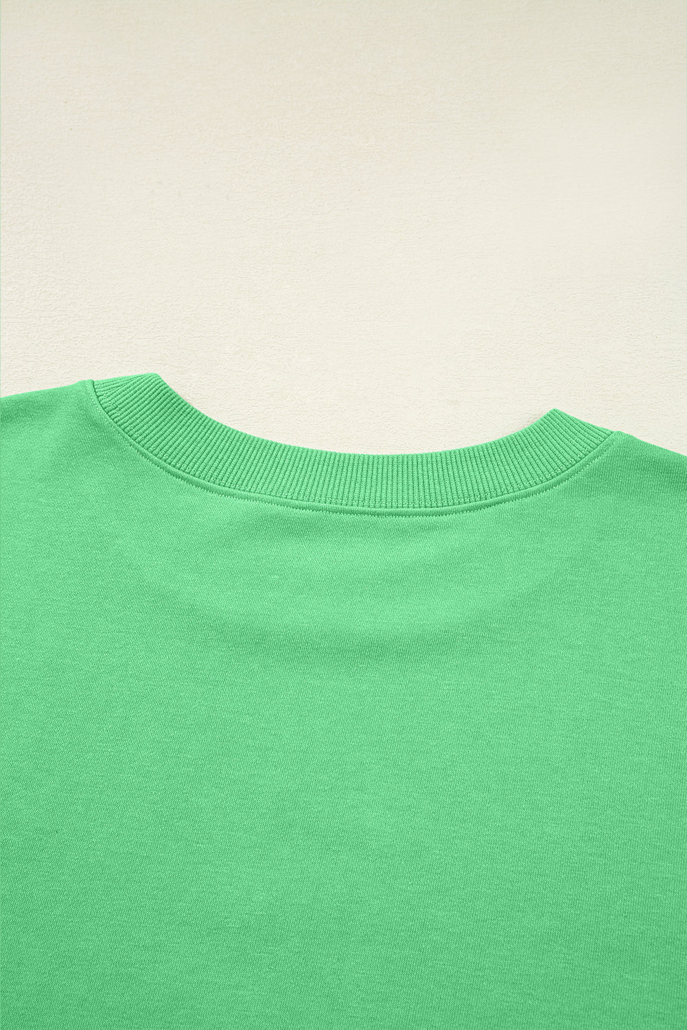 Back neckline detail of green Drop Crop Wide-Leg Pants Set, showcasing soft ribbed collar for added comfort.