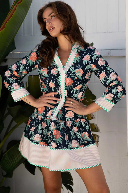 Ladies blue floral shift mini dress with striped trim, featuring a relaxed H-line silhouette and bohemian floral print, ideal for spring wear.