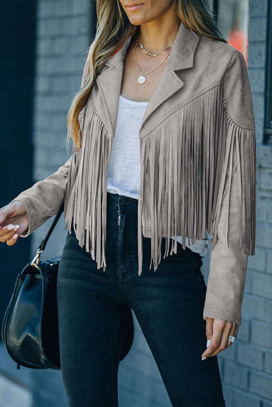 Ladies gray cropped fringe faux suede jacket with open front and long sleeves, styled with black jeans and a white top for a casual western look.