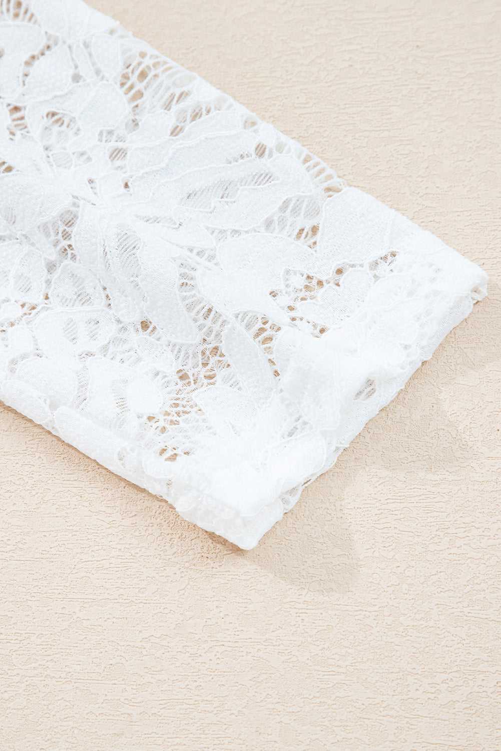 Detailed view of the white lace sleeve on the Lace Sleeve Drop T-Shirt - Soft & Comfy | FashionFitz, showcasing its floral lace pattern.