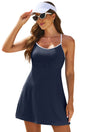 Woman in a navy blue dress and white visor on a beach