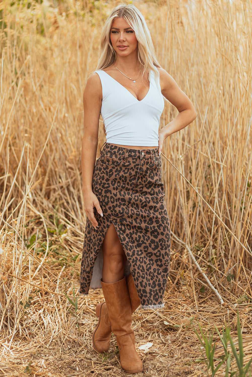 Model posing in Leopard Denim Midi Skirt - Summer Fashion by FashionFitz with white sleeveless top and tan boots in nature setting.