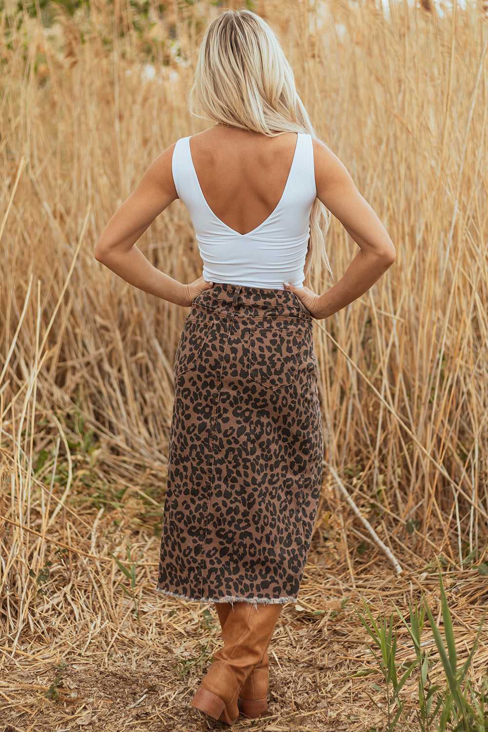 Back view of model in Leopard Denim Midi Skirt - Summer Fashion by FashionFitz, styled for summer with sleeveless top and boots.