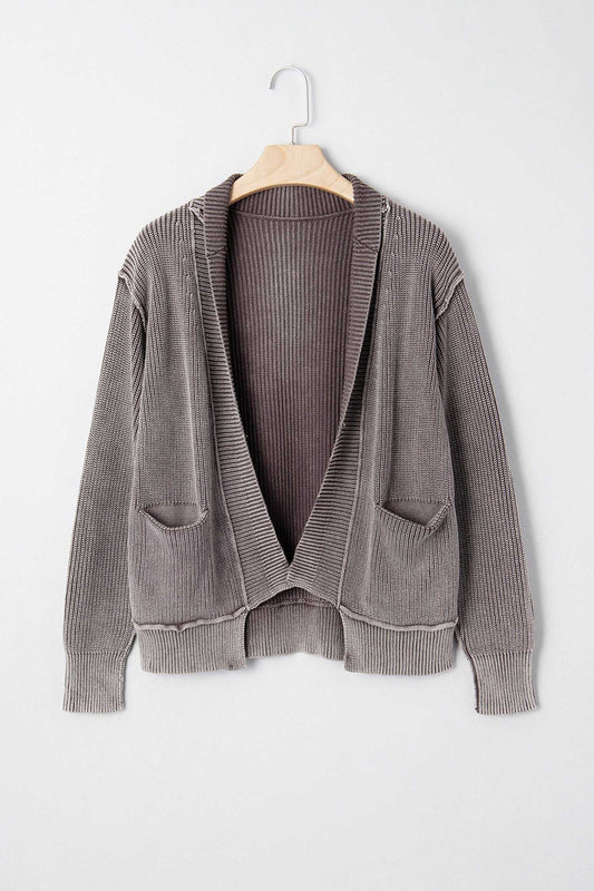 Brown stonewash patchwork knit open cardigan on hanger, featuring front pockets and ribbed knit texture, perfect for layering in fall.