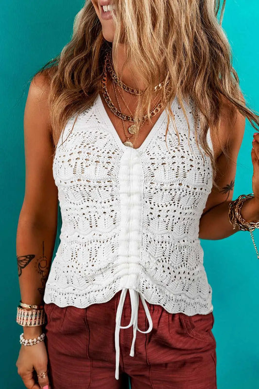 Glamour crochet tank top in white with drawstring front, styled with layered necklaces and red shorts for a chic summer look.