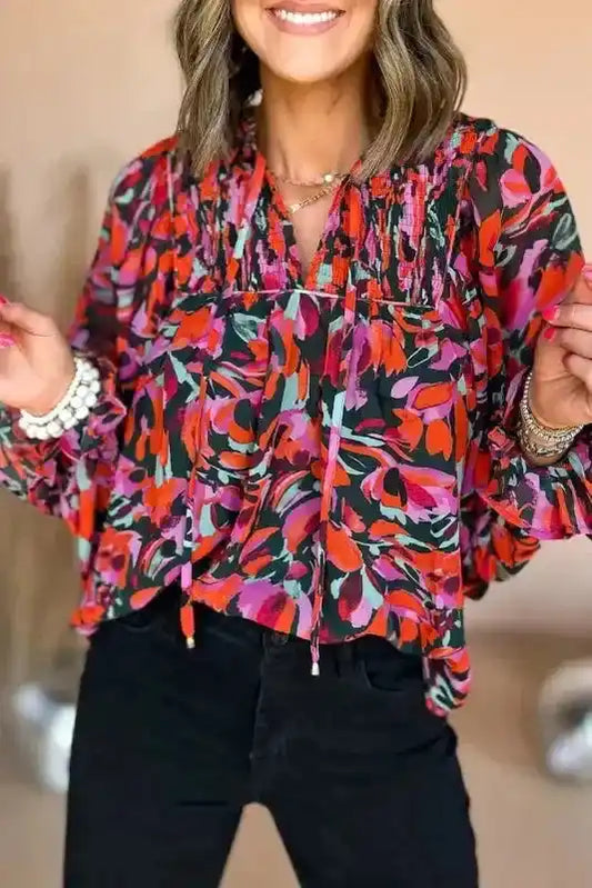 Abstract Floral Shirred Puff Sleeve Blouse | FashionFitz styled with black jeans, showcasing its vibrant multicolor floral print and smocked neckline.