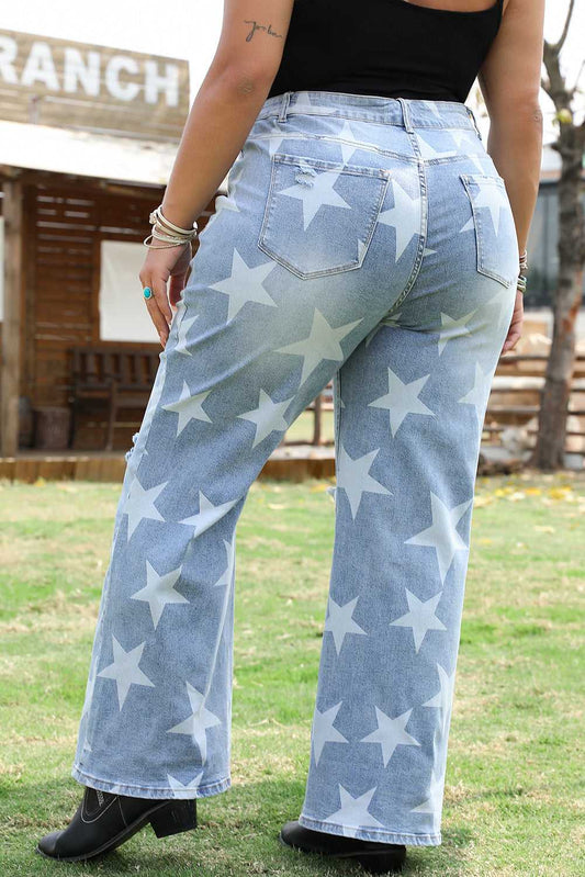 Back view of distressed plus size jeans in blue denim featuring bold white star print and wide-leg cut, ideal for daily western style.