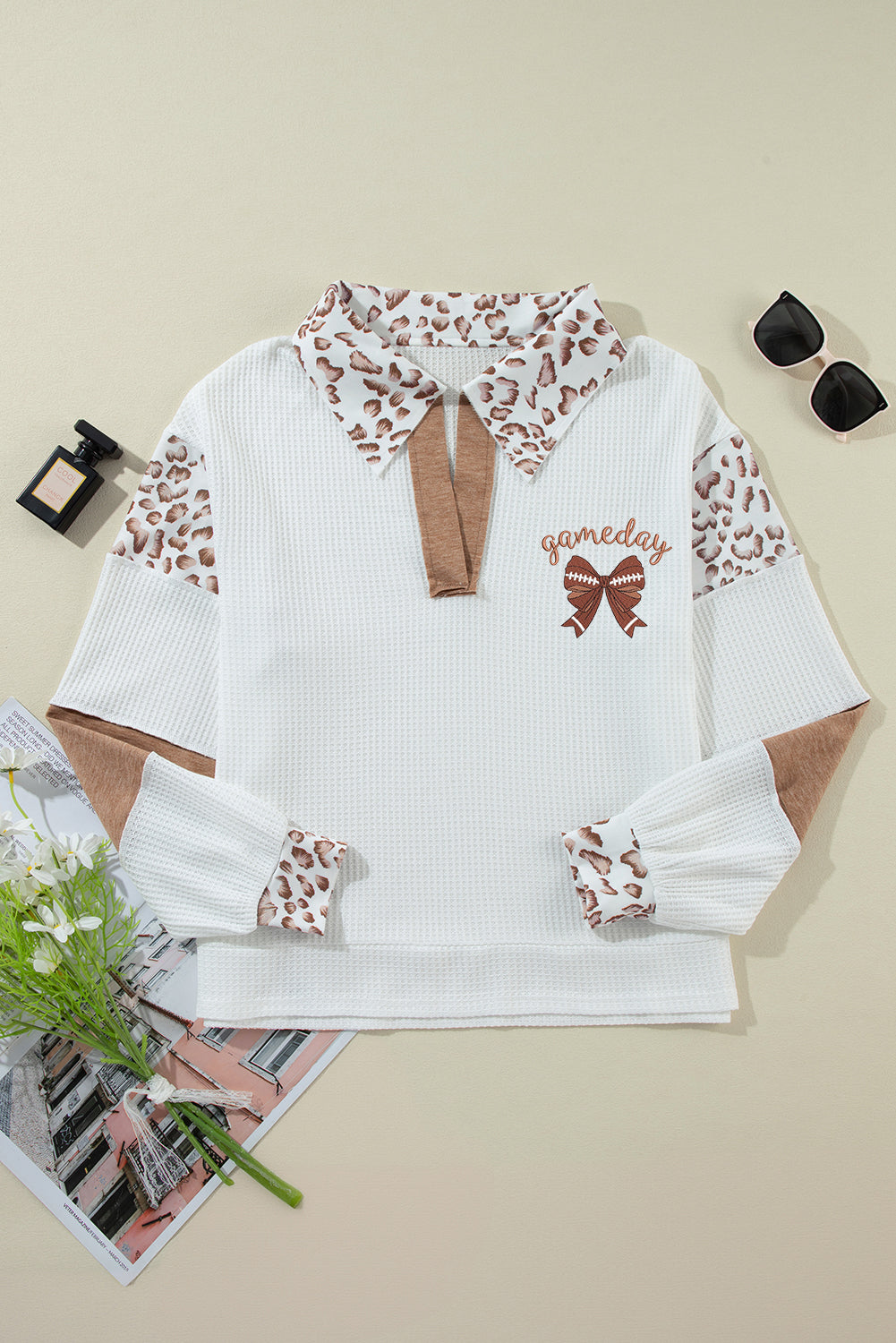 Embroidered Leopard Polo – Chic White Long Sleeve Top with leopard print collar and sleeves, brown bow detail, and 'gameday' text embroidery.