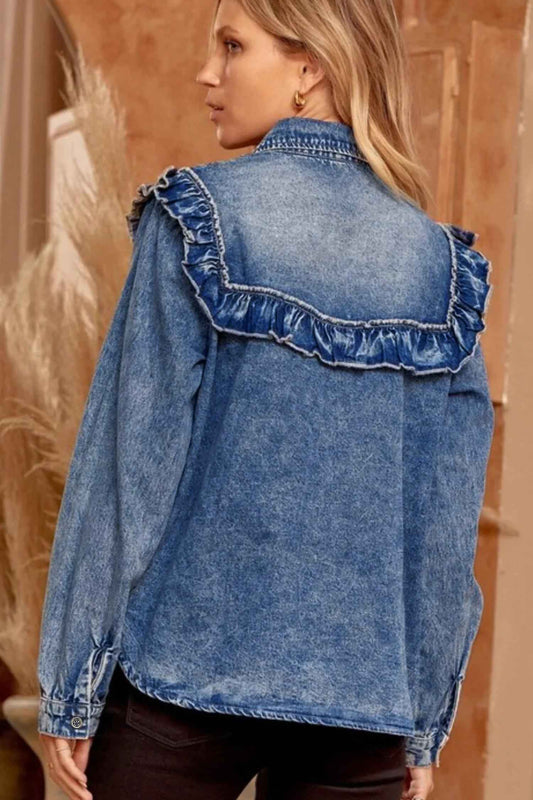 Blue denim jacket with ruffled details worn by a person, against a neutral background.