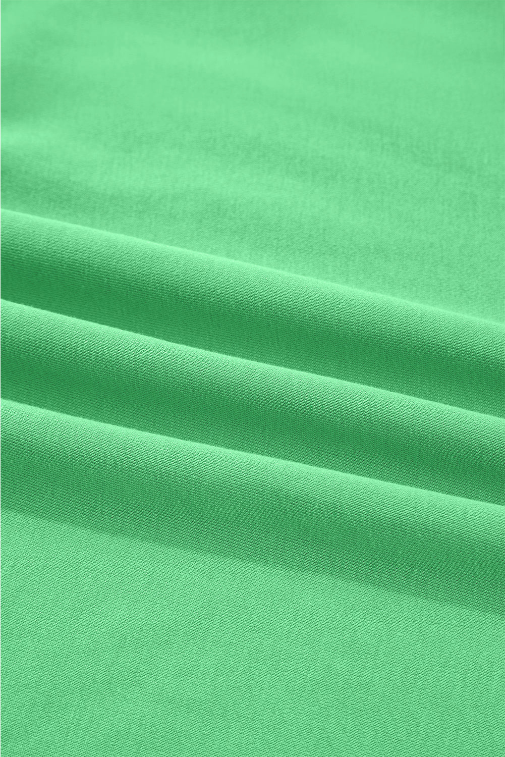 Close-up of green Drop Crop fabric texture, emphasizing soft, breathable material ideal for fall loungewear sets.