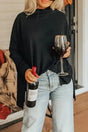 Black cowl neck shift tunic top with long sleeves styled casually with light-wash jeans, ideal for layering in cool weather.