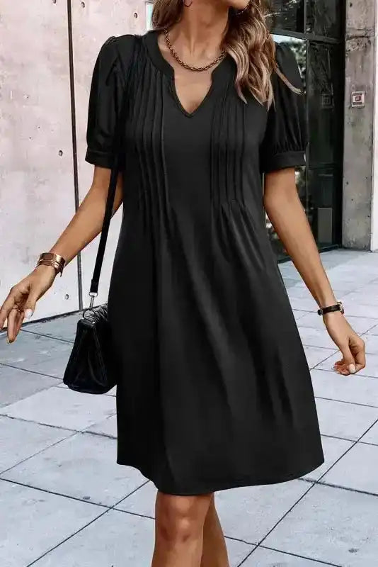 Front view of black Notched Pleat Puff Sleeve Shift T-Shirt Dress featuring soft pleats and flattering V-notch neckline.