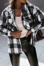 Black plaid shacket for winter outfits styled with faux leather pants and a white top, perfect for modern cold-weather looks.