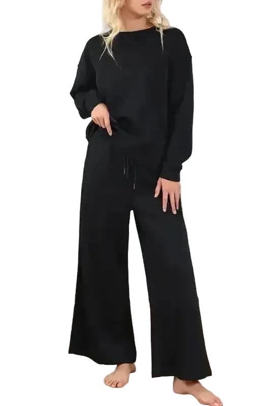 Women's black textured loungewear set with slouchy fit, featuring wide-leg pants and long-sleeve top for cozy casual wear.