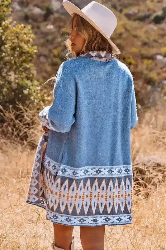 Back view of Blue Aztec Knit Duster Cardigan showcasing detailed Aztec print hem and relaxed fit for a cozy winter look.