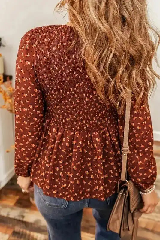 Back view of Boho Floral Peplum Blouse showcasing smocked detailing and floral pattern for a flattering silhouette.