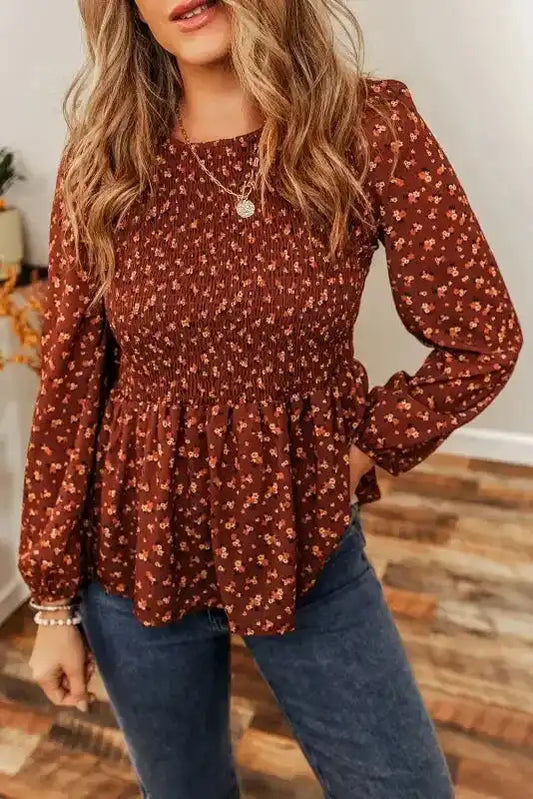 Boho Floral Peplum Blouse in rust brown with long sleeves and smocked bodice, styled with jeans for a unique feminine look.