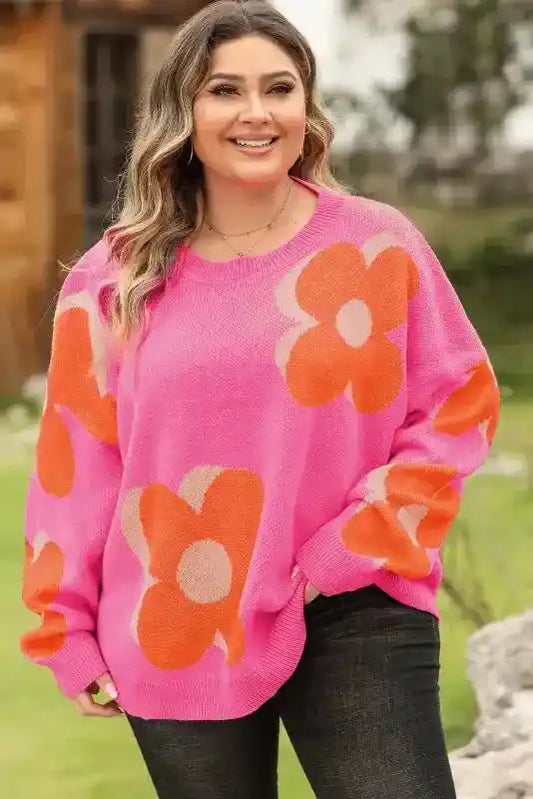 Bonbon Plus floral sweater in vibrant pink with oversized orange flowers, styled for plus-size comfort and casual daily wear.