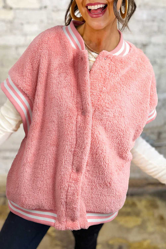 Model wearing varsity pink plush vest with zip front and high collar