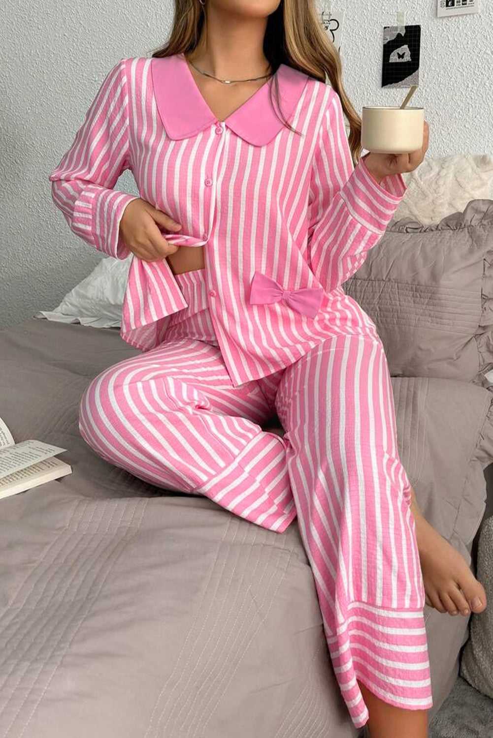 Model wearing pink stripe pyjama set with button-up top and long sleeves