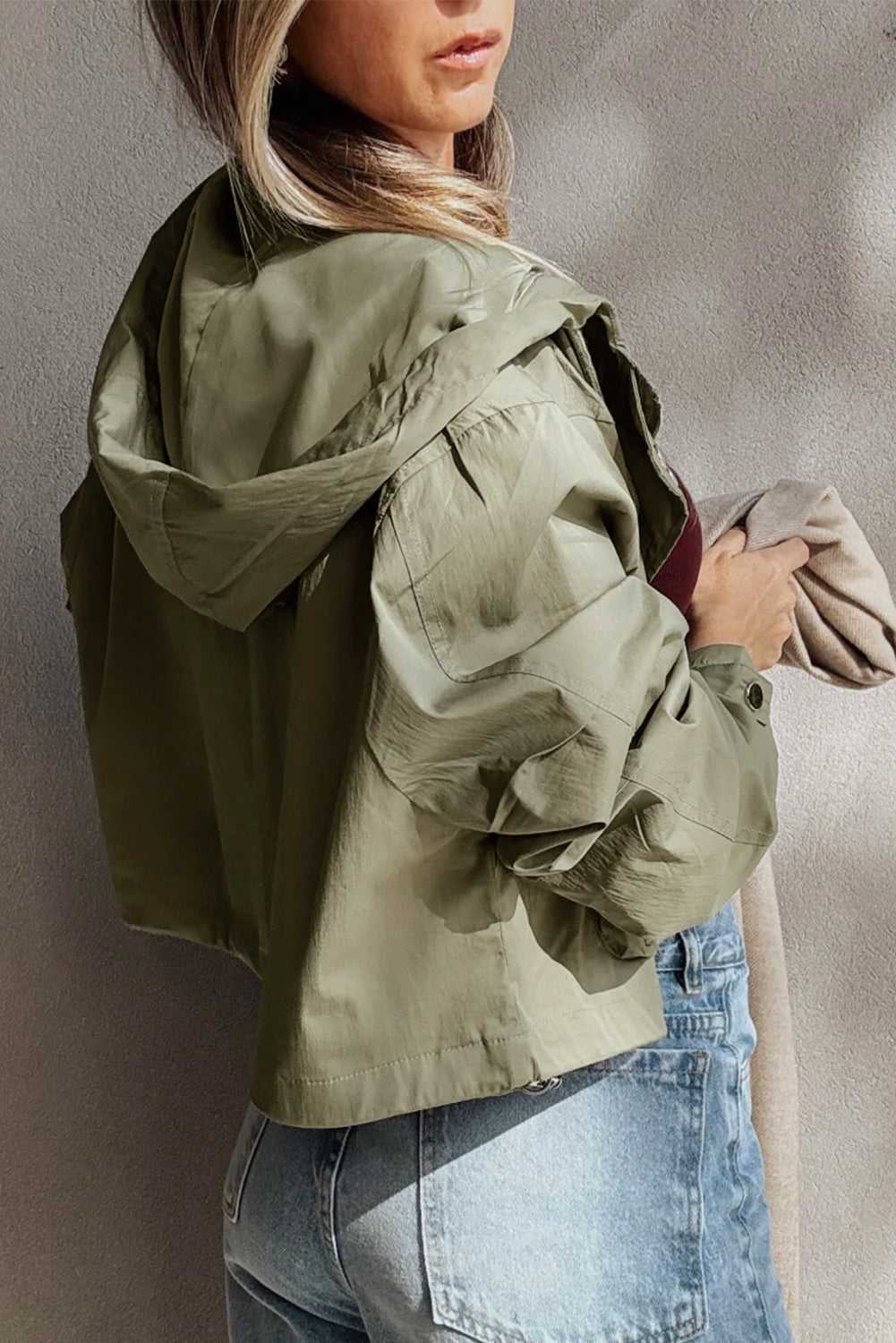 Back view of Cropped Hooded Utility Jacket in laurel green, highlighting relaxed fit and hood design for versatile autumn styling.