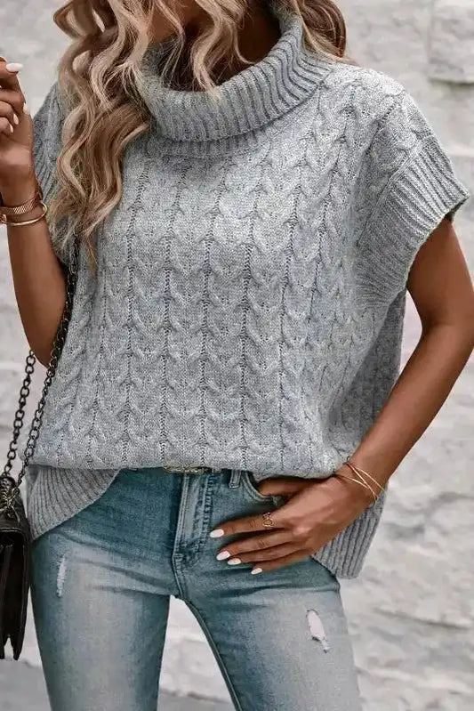 Women's grey cable knit turtleneck short sleeve jumper styled with ripped jeans. Lightweight and stretchable knitwear top for casual wear.