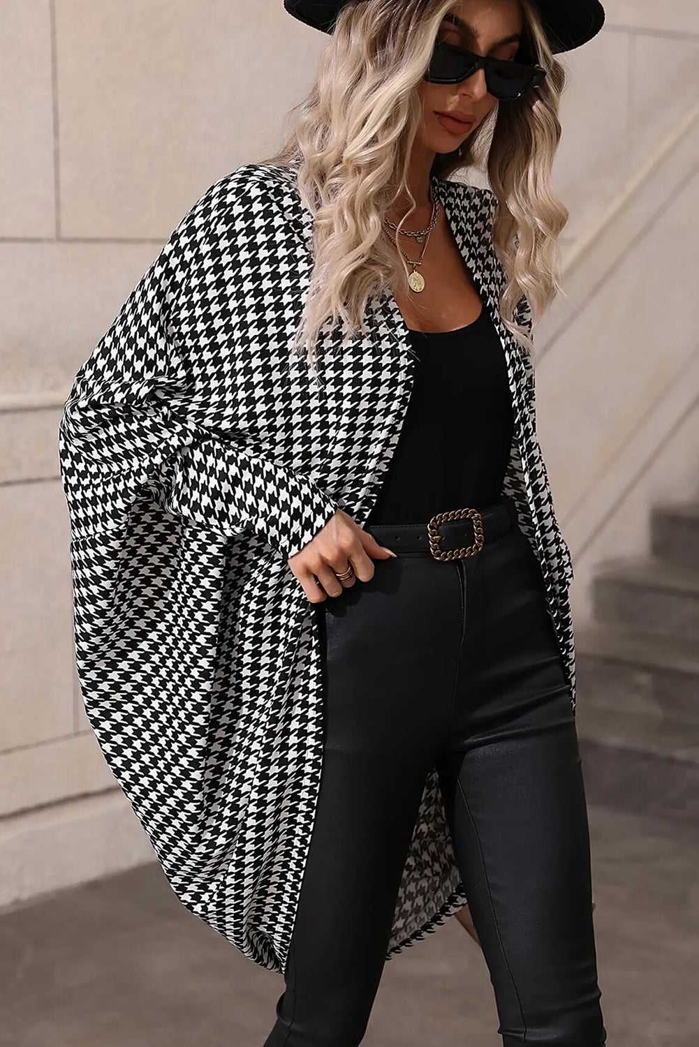 Model wearing black houndstooth kimono wrap with dolman sleeves
